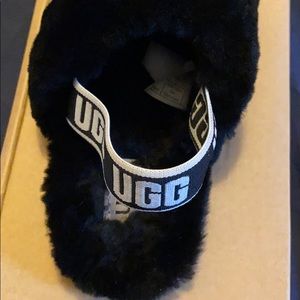 A pair of toddler girl ugg slides in a size 9